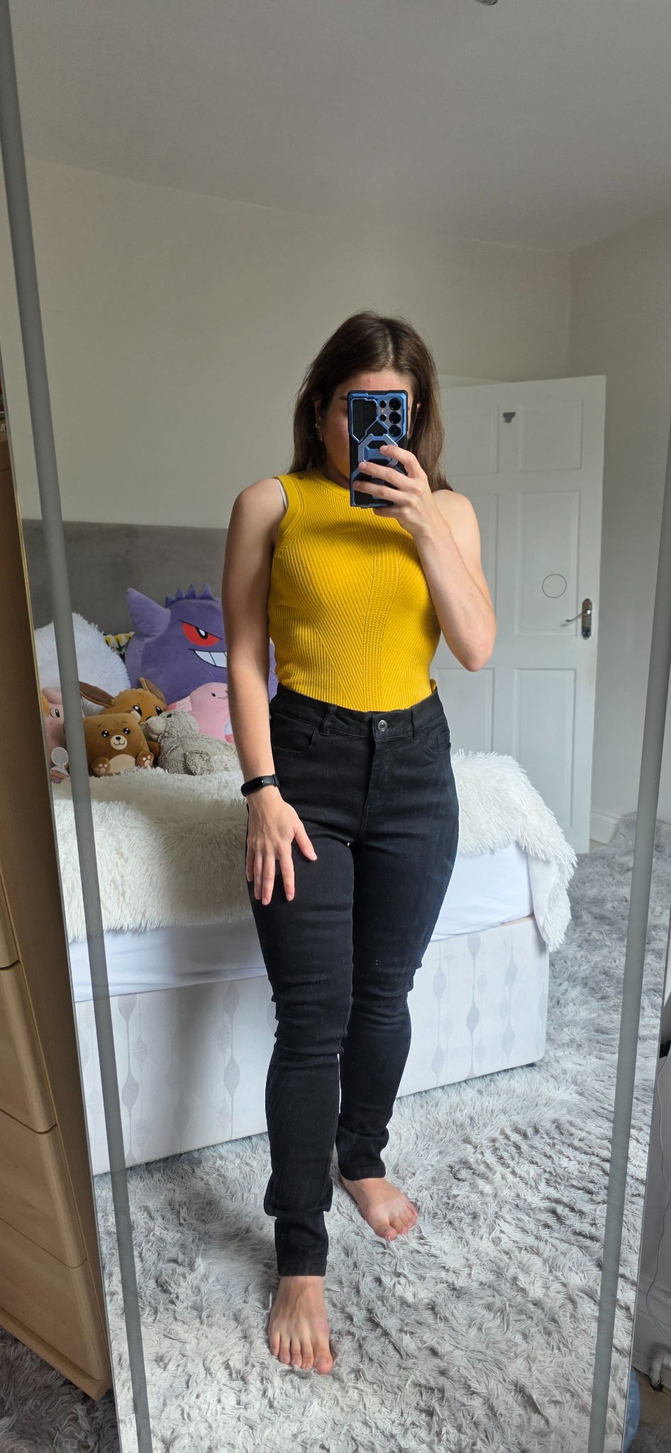 Mustard yellow M&S Collection ribbed vest top styled with black jeans