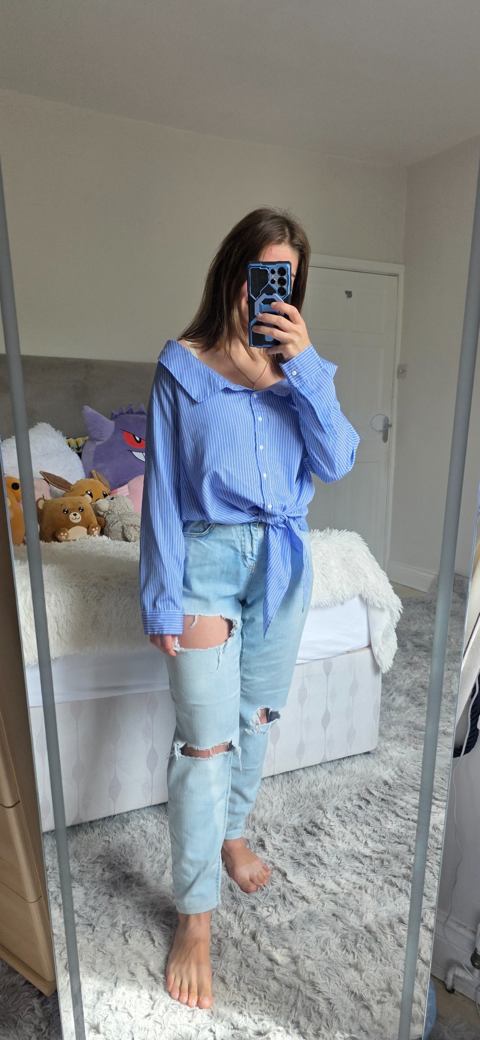 Blue and white pinstripe Bardot blouse styled off the shoulder with light jeans