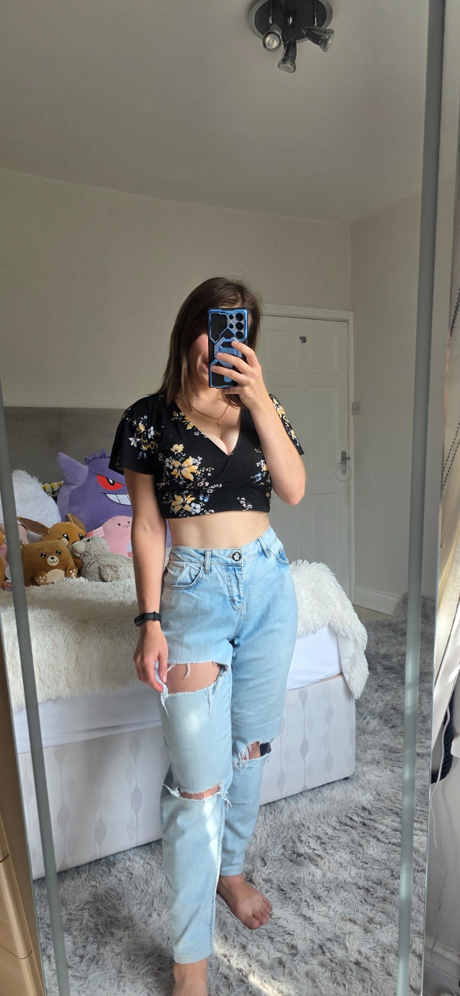 Light-blue Sinners Attire ripped jeans styled with a black floral top